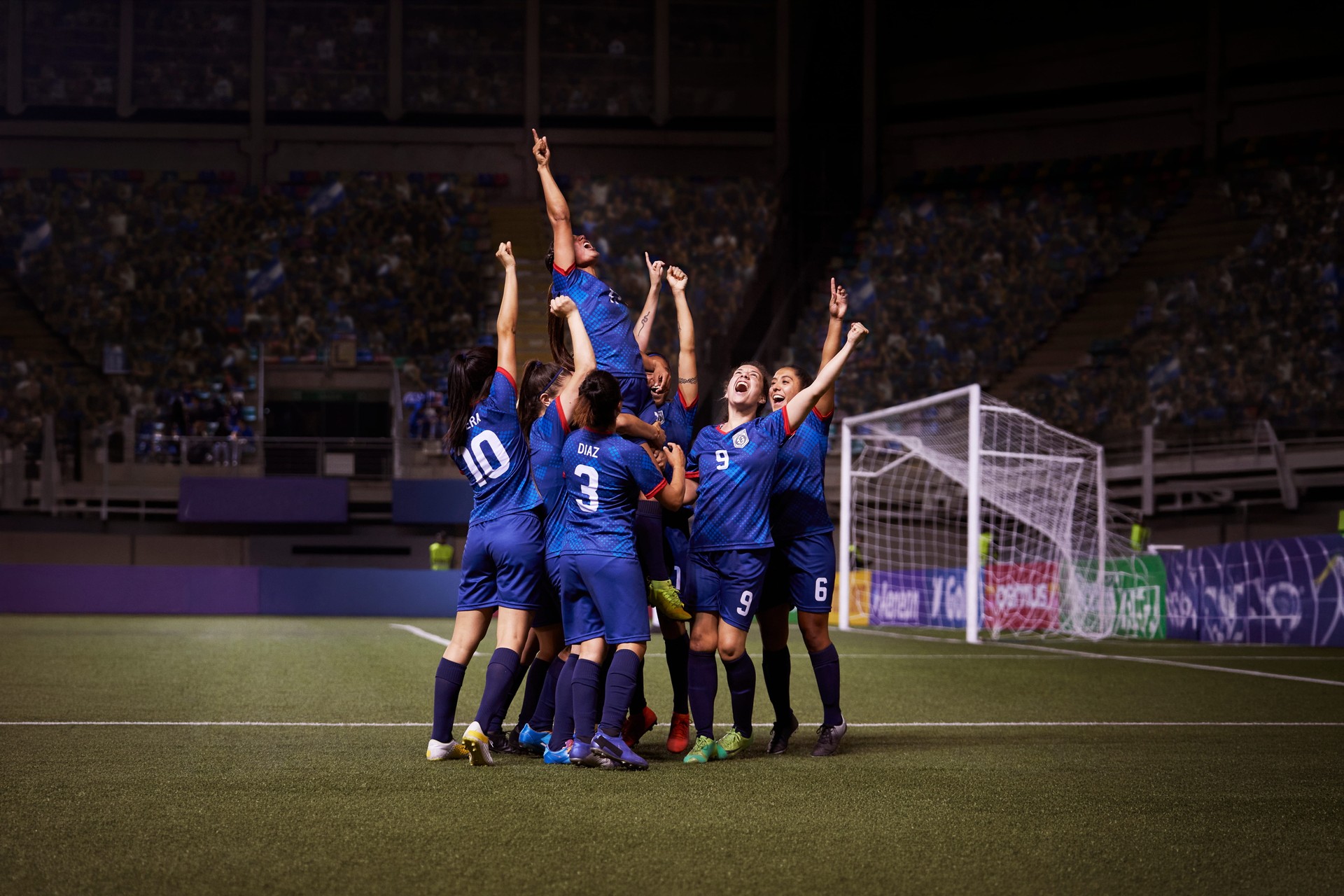 soccer team of women cheering after winning a soccer game